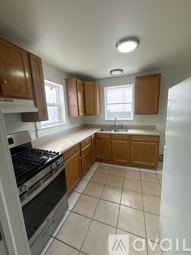 A kitchen with wooden cabinets and a stove top oven.
