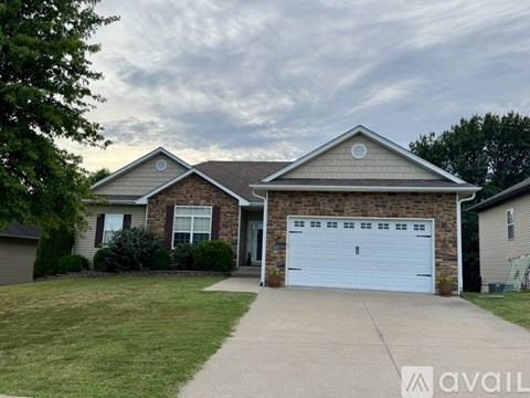 A house with a garage is available for sale.