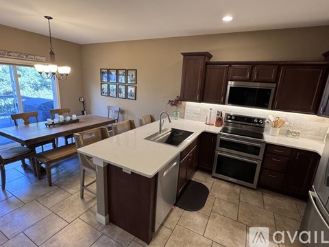 A kitchen with brown cabinets and a white island.