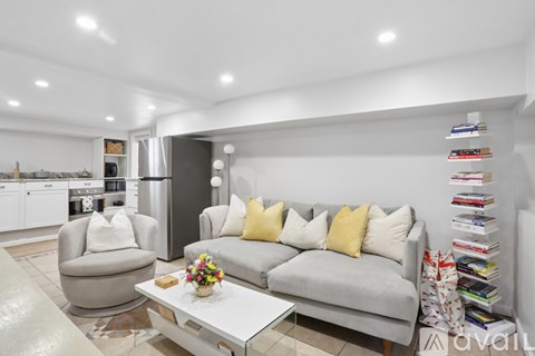 A living room with a grey couch and a coffee table.