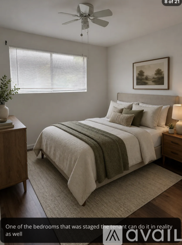 A bedroom with a bed, nightstand, and a ceiling fan.