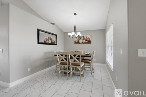 A dining room with a table set for four.