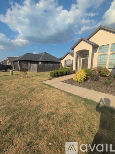 A house with a lawn in front of it.