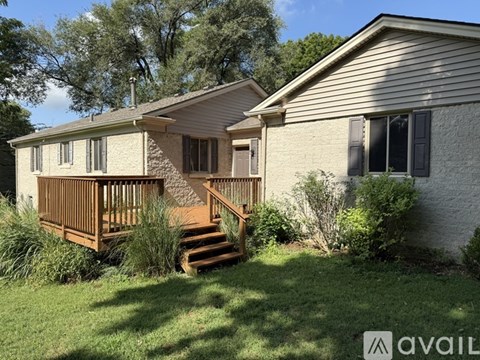 A house with a deck and a covered patio is for sale.