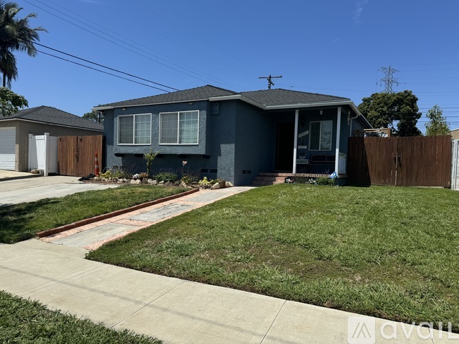 A house with a grey exterior and a brown fence.