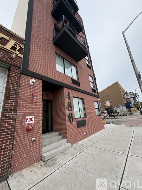 A red brick building with the number 486 on it.