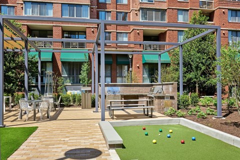 A patio area with a lawn and a pool table.