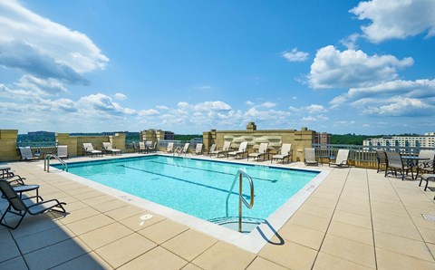 A large outdoor swimming pool surrounded by lounge chairs.