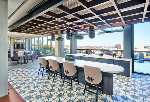 A modern dining area with a long table and chairs.