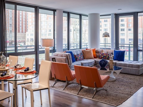 A living room with a glass table and chairs.