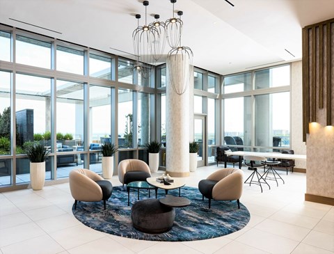 A modern living room with a large table and chairs.