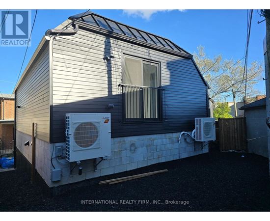 A mobile home with a white air conditioning unit on the side.