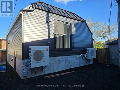 A mobile home with a white air conditioning unit on the side.