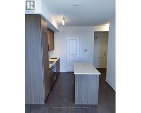 A kitchen with wooden cabinets and a white counter.