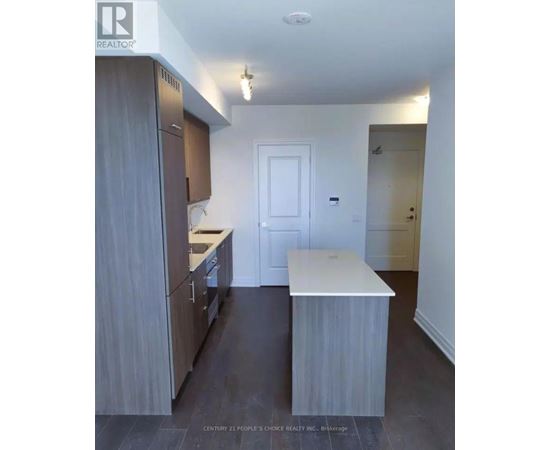 A kitchen with wooden cabinets and a white counter.