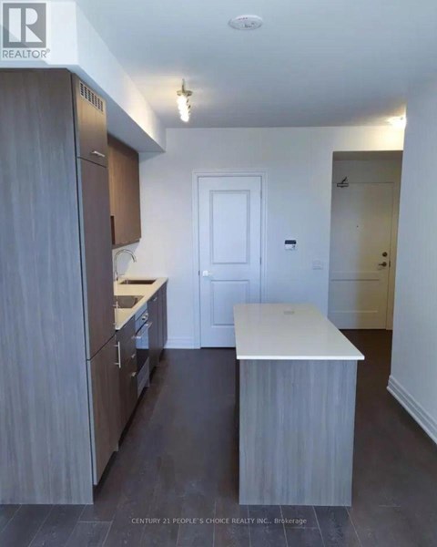 A kitchen with wooden cabinets and a white counter.