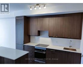 A kitchen with brown cabinets and a white countertop.