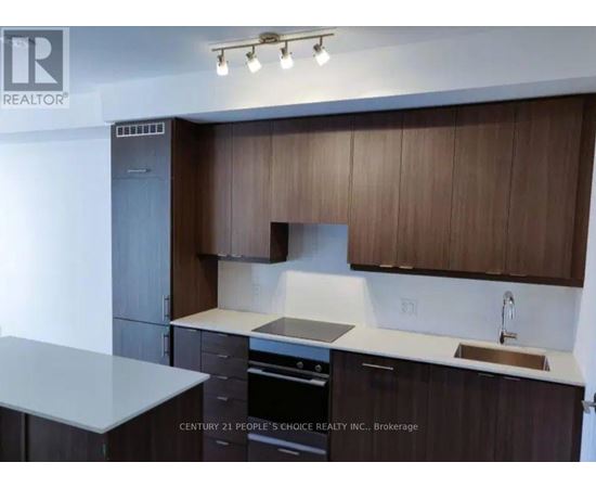 A kitchen with brown cabinets and a white countertop.