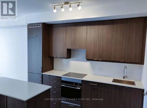 A kitchen with brown cabinets and a white countertop.
