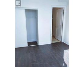 A room with a white door and a white closet with a shelf.
