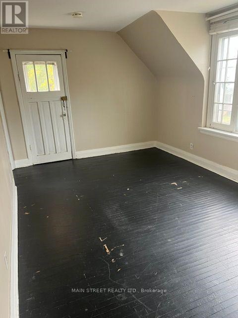 A room with a white door and a window.