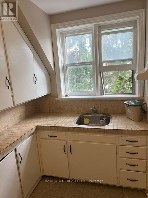 A kitchen with a window and a sink.