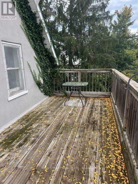 A wooden deck with a table and chairs.