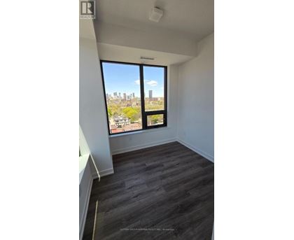 A room with a large window overlooking a cityscape.