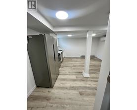 A spacious room with a refrigerator and a countertop.