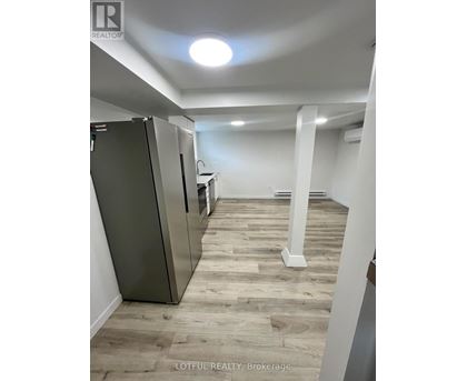 A spacious room with a refrigerator and a countertop.