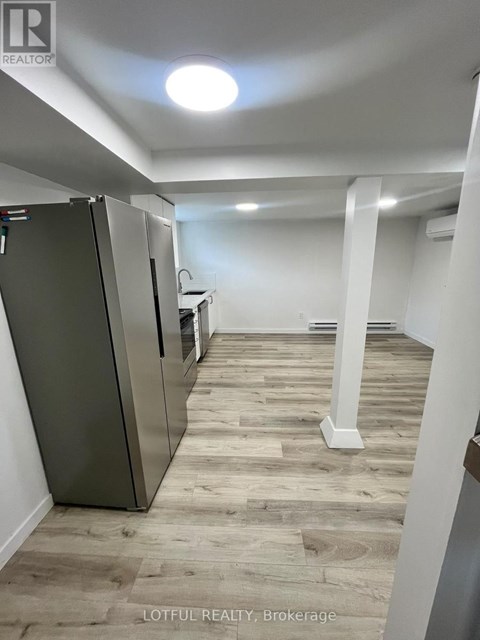 A spacious room with a refrigerator and a countertop.