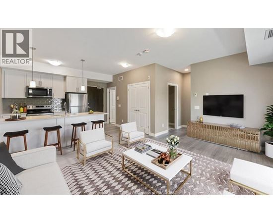 A living room with a white couch and a coffee table in the center.