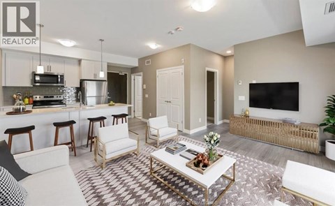 A living room with a white couch and a coffee table in the center.