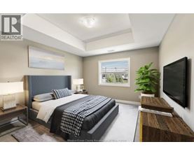A bedroom with a large bed and a television on the wall.