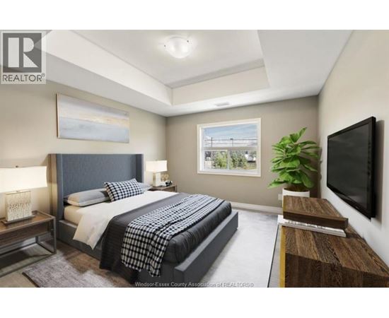 A bedroom with a large bed and a television on the wall.