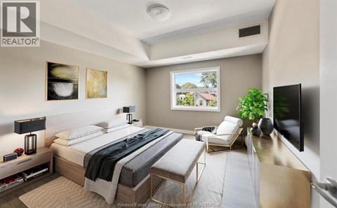 A bedroom with a large bed and a flat screen TV mounted on the wall.