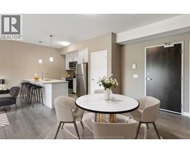 A modern dining room with a round table and chairs.