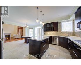 A modern kitchen with dark wood cabinets and a central island.