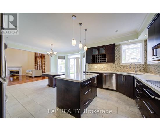 A modern kitchen with dark wood cabinets and a central island.