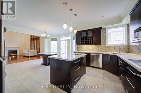 A modern kitchen with dark wood cabinets and a central island.