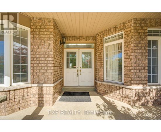 The entrance of a house with a white door and windows on either side.