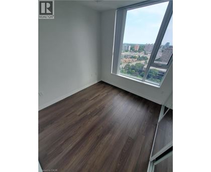 A room with a large window overlooking a cityscape.