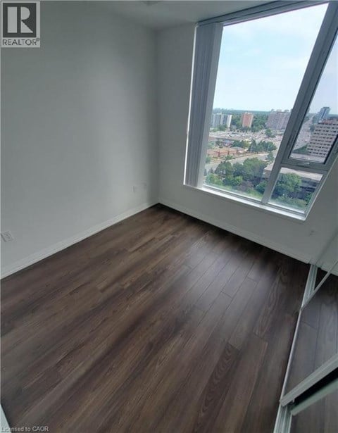 A room with a large window overlooking a cityscape.