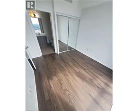 A room with wood flooring and a sliding glass door.