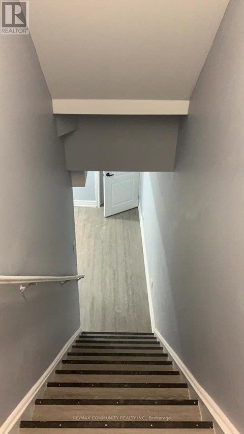 A long flight of stairs leading to a door.