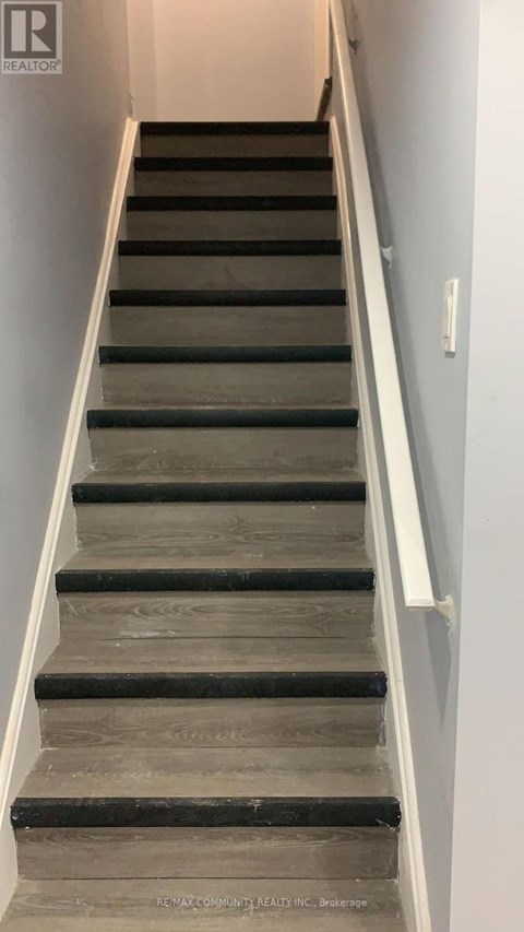 A staircase with wooden steps and white handrails.