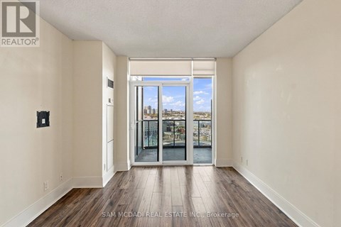 A room with a view of the city through a glass door.