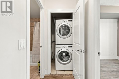 A washer and dryer are in a small laundry room.