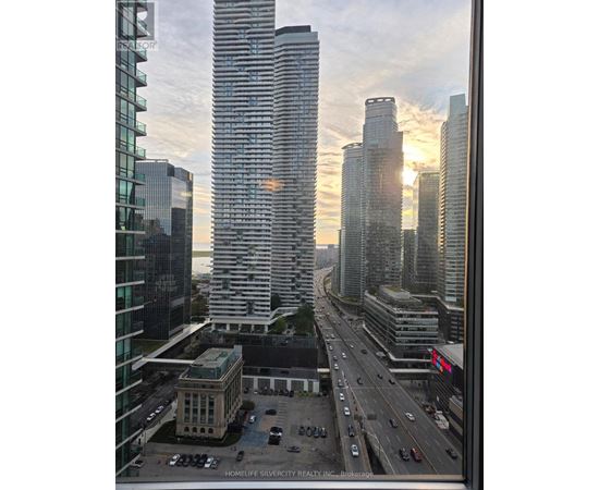 A cityscape with a highway and buildings, including one with the text "HOMELIFE SILVERCITY REALTY INC. Brokerage".
