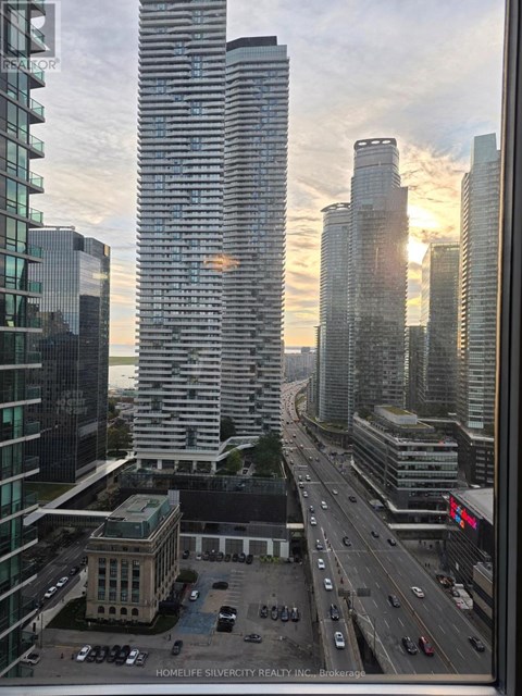 A cityscape with a highway and buildings, including one with the text "HOMELIFE SILVERCITY REALTY INC. Brokerage".